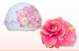Crochet baby and girls hats come in a variety of different colors with velvet, silk and organza flowers. Embellished with Swarovski crystals and matching color ribbons. All hats come individually packaged in clear PVC boxes. Perfect for gifts.